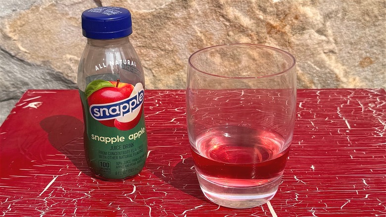 Snapple Apple juice on red table