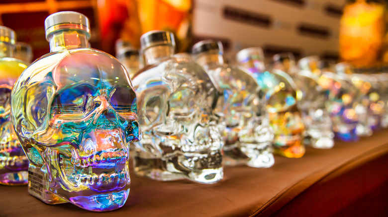 row of crystal head vodka bottles on shelf