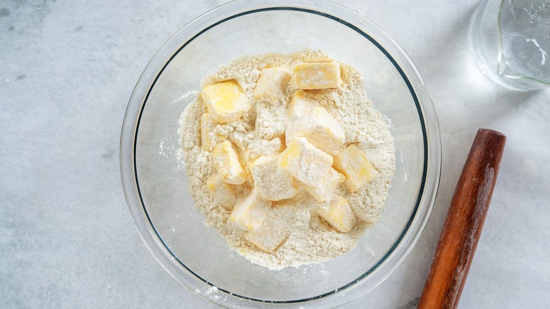 Cold butter and flour in bowl on countertop