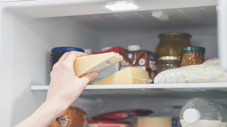 placing a piece of cheese in the refrigerator