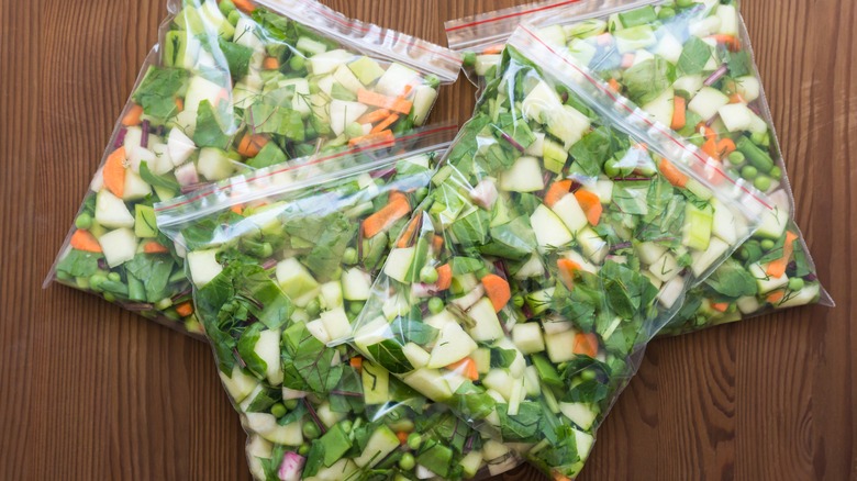 Four zip-top plastic bags filled with veggies