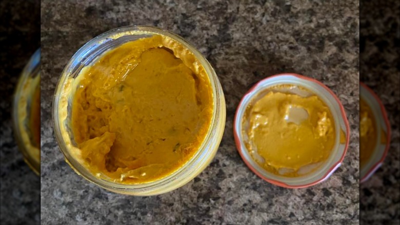 An overhead view of an open jar of Casa Mamita Salsa Con Queso
