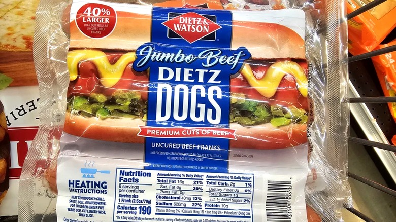 Package of Dietz and Watson jumbo beef hot dogs in shopping cart