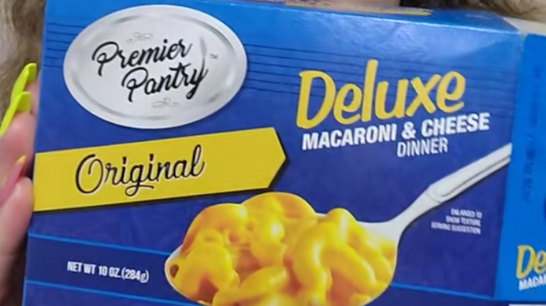 Close-up on a box of Premiere Pantry deluxe Macaroni & Cheese Dinner