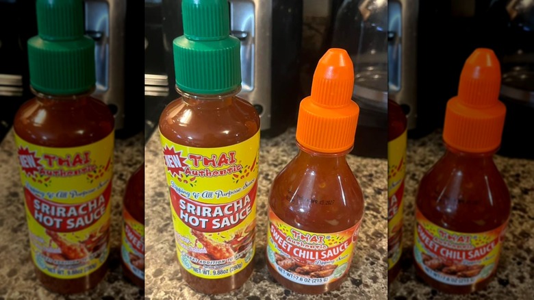 Thai Authentic brand hot sauce bottles posed on a granite countertop