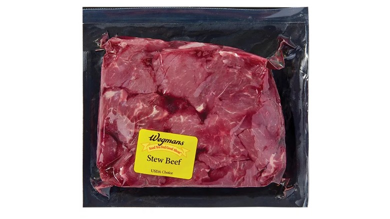 Wegmans packaged raw stew meat on a white background