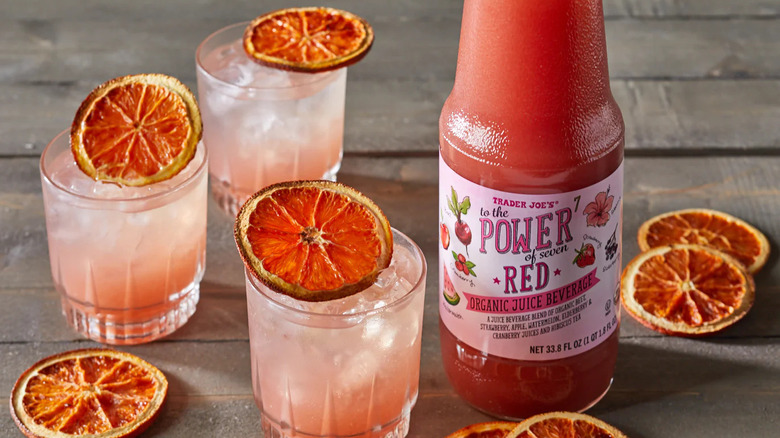 Trader Joe's to the power of seven red juice bottle with glasses and dried fruit slices