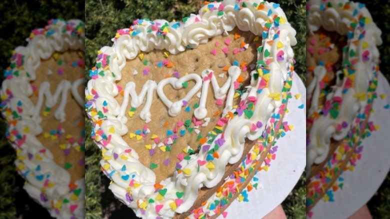 Hand holding Mom heart cookie cake