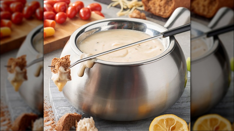 Dripping cheese fondue with bread and vegetables at the Melting Pot