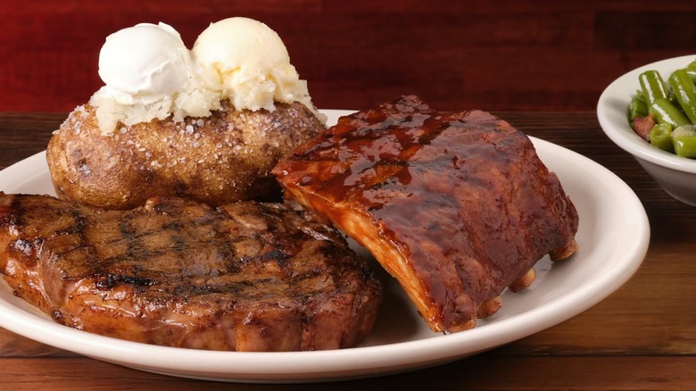 Texas Roadhouse's 12-ounce ribeye and ribs plate with a baked potato and green beans
