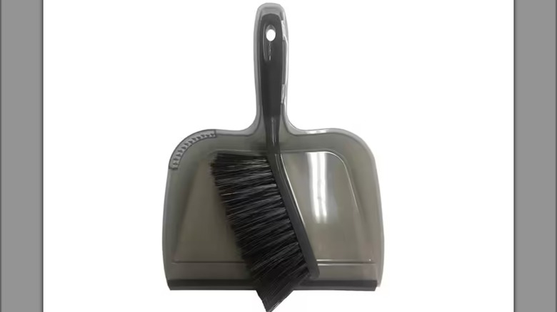 greay dustpan with small brush