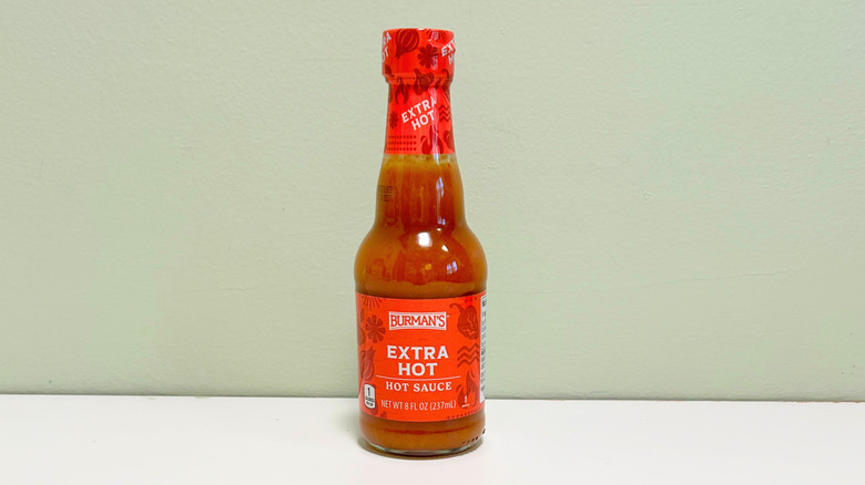 A bottle of Burman's Extra Hot Hot Sauce