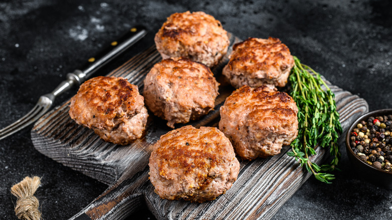 Pork patties on a board