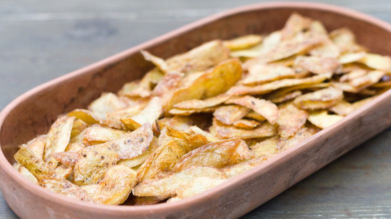 Potato skins in wooden tray