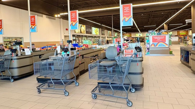 An Aldi checkout area with empty carts, and the store in the background