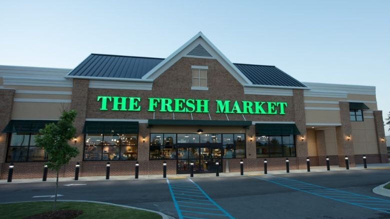 The exterior if a The Fresh Market location from a parking lot