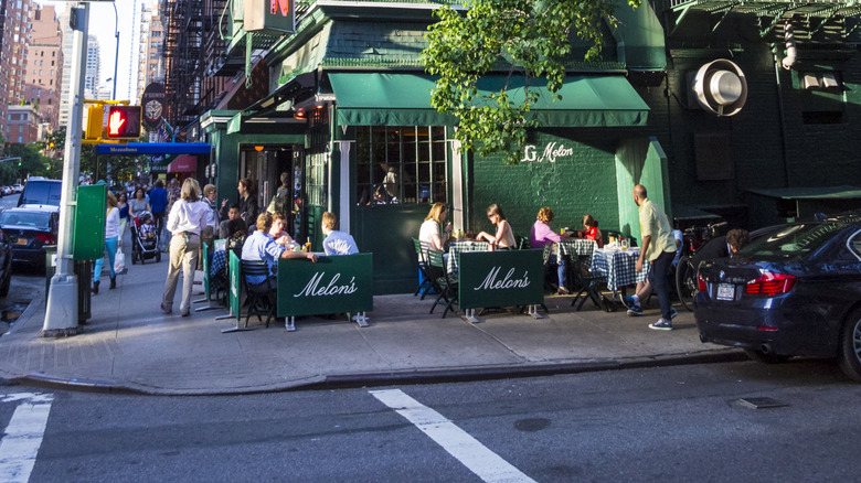 The green building exterior of J.G. Melon in NYC