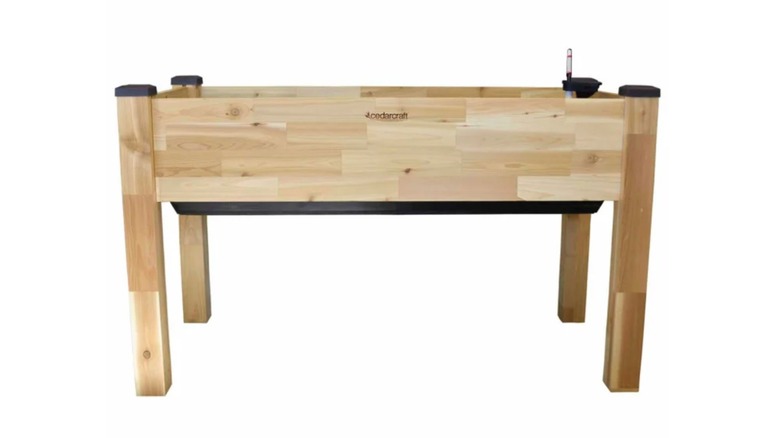 A wooden Self-watering Elevated Garden Planter