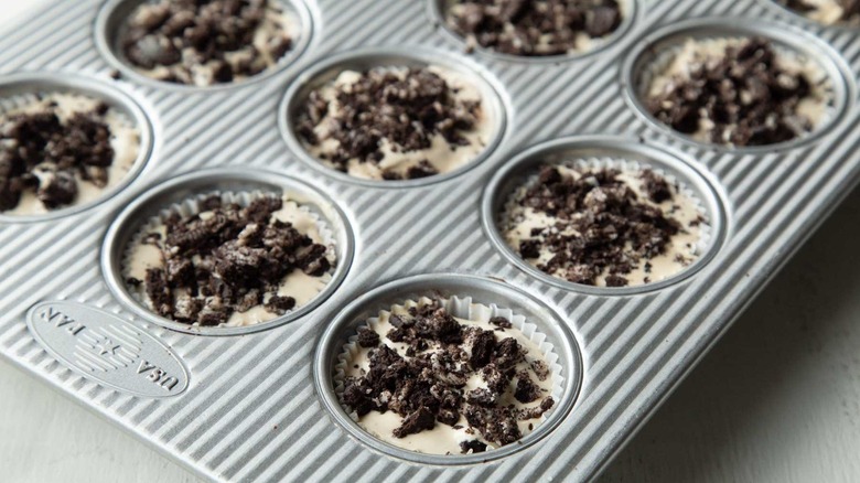 ice cream and cookie pieces in muffin cups