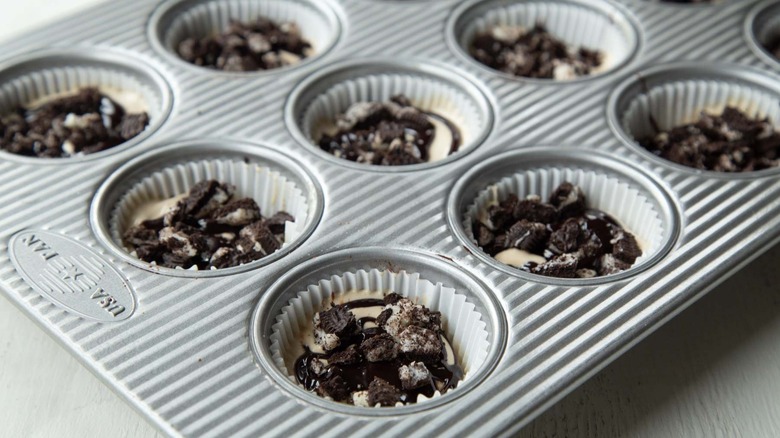 ice cream, cookies, and fudge sauce in muffin cups