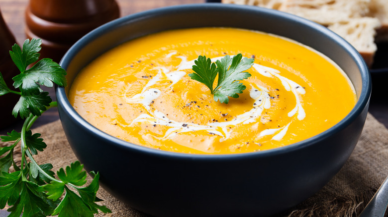 Pumpkin soup in bowl with parsley