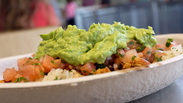 A rice bowl from Chipotle topped with guacamole
