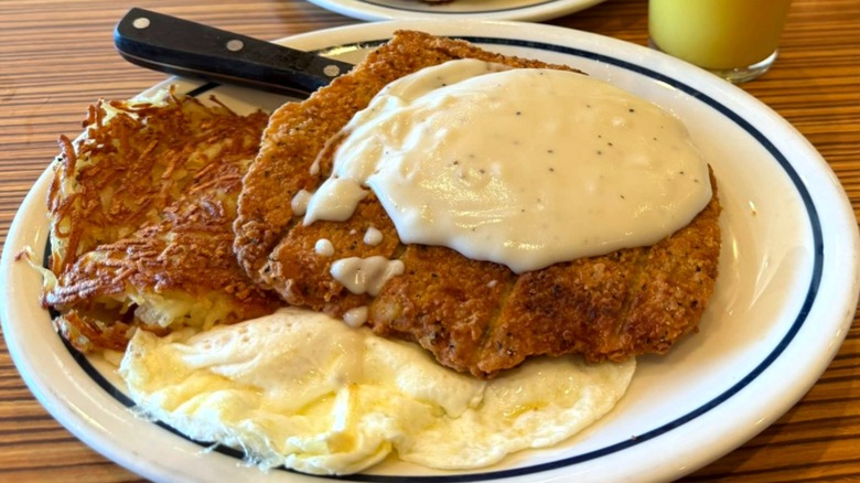 A chicken fried steak with gravy, hashbrowns, and overeasy eggs at IHOP