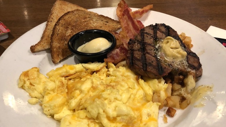 TGI Fridays steak and eggs, with toast, bacon, and butter