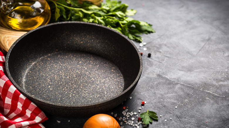 Cast iron pan with oil, herbs, and salt