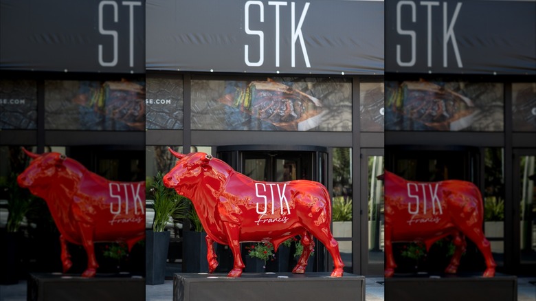 An STK restaurant exterior featuring "Francis," a STK-branded Red Bull statue