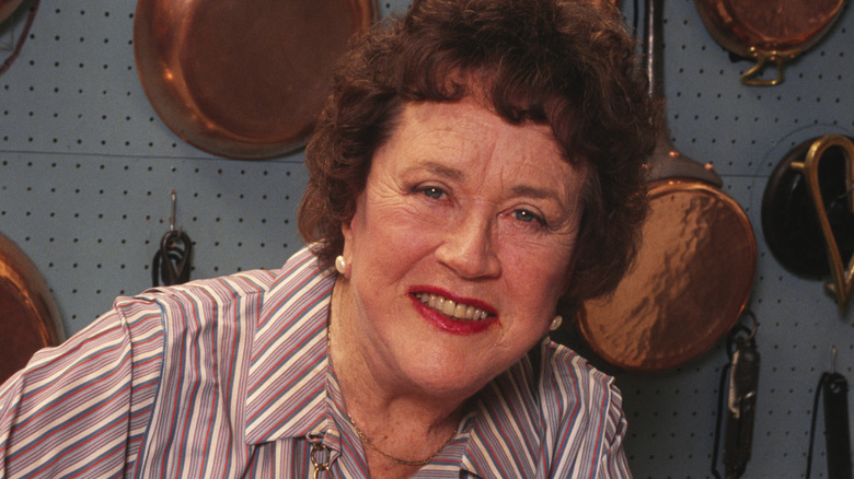 Julia Child smiles for photo in kitchen
