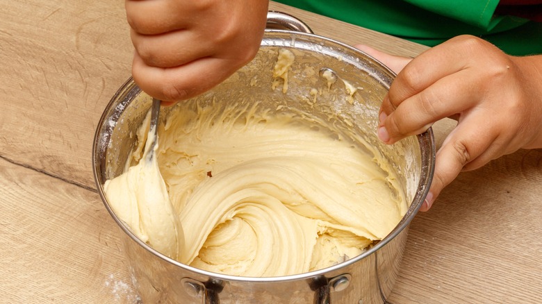 a person stirring cake batter