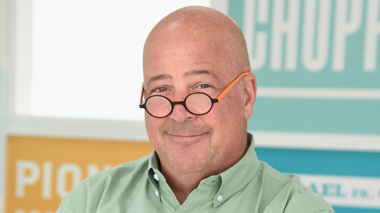 Andrew Zimmern smirking in glasses