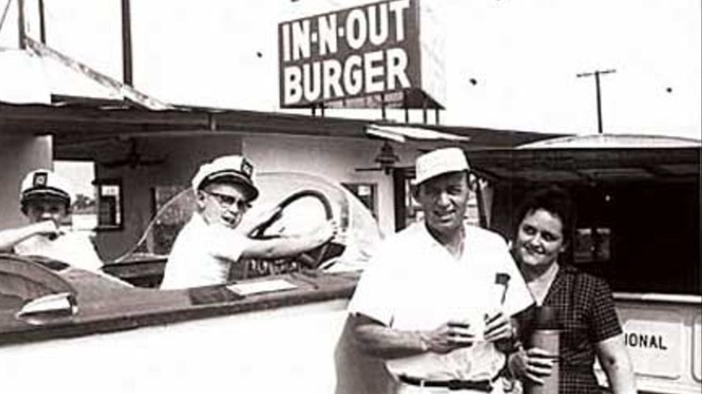 Harry and Esther Snyder standing in front of their In-N-Out Burger