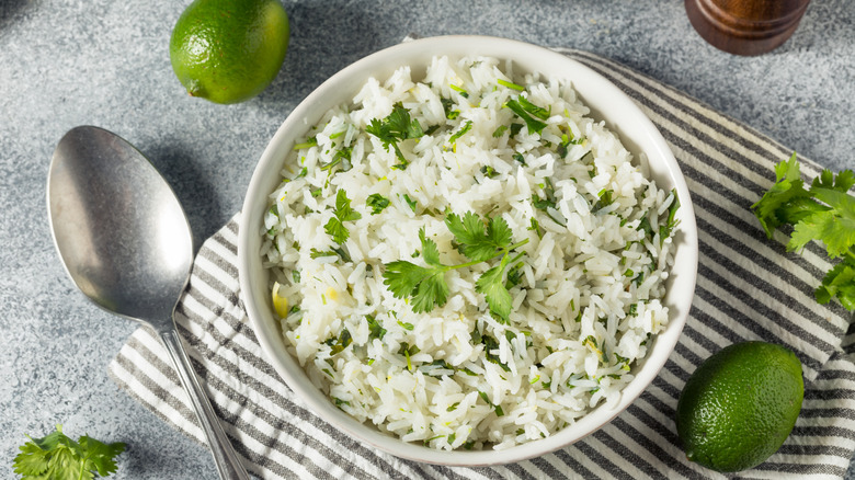 Cilantro lime rice with fresh limes and herbs