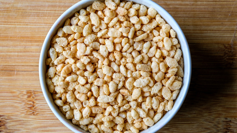 Close-up, top-down view of a bowl of Rice Krispies on a wood table