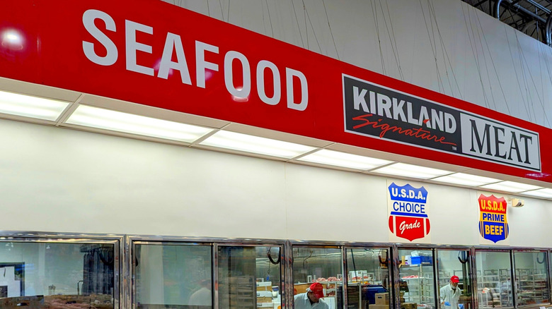 Photo of a Costco meat department, focused on the word "seafood" in the sign