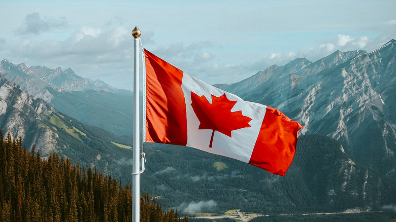 Canadian flag mountain backdrop