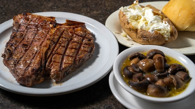 York Steak House steak dinner with muchsroom and baked potato sides.