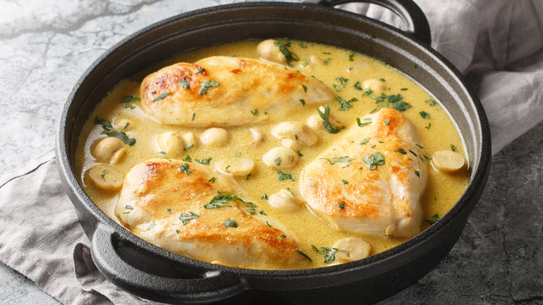 A French chicken-based dish in a shallow black pan