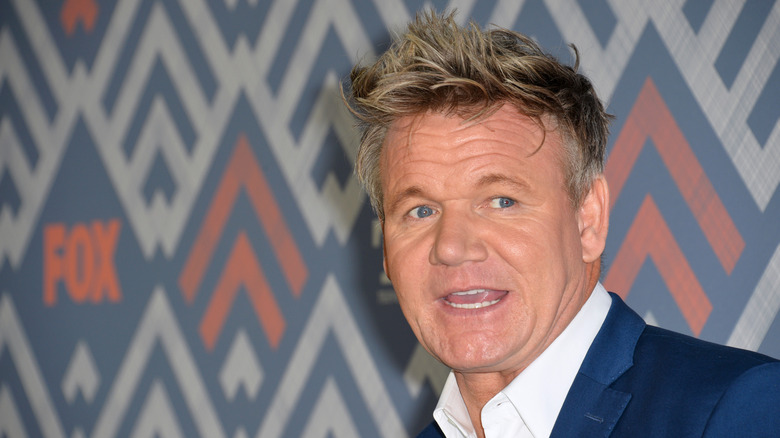 Gordon Ramsay in a blue suit on a red carpet