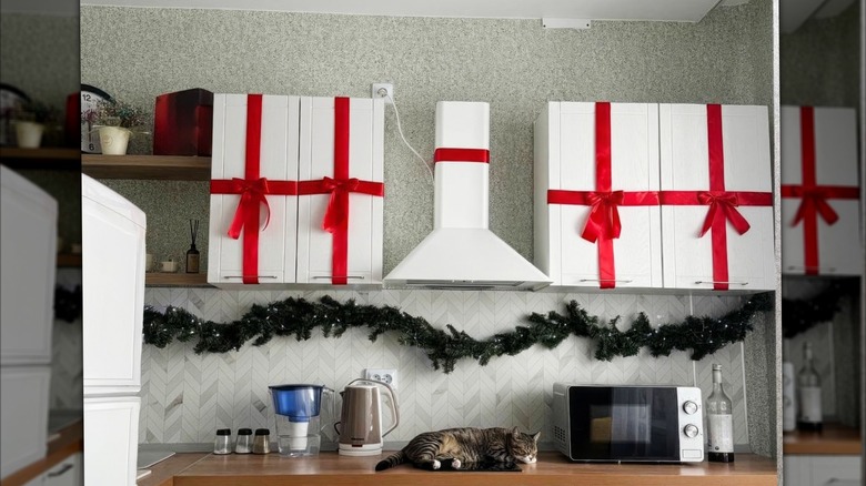 kitchen cabinets wrapped in oversized, red bows