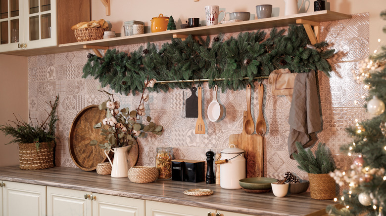 Stylish kitchen with festive decor and Christmas garland.