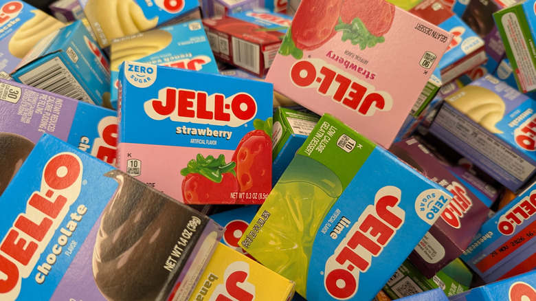 An unorganized pile of Jell-O gelatin and pudding mix boxes