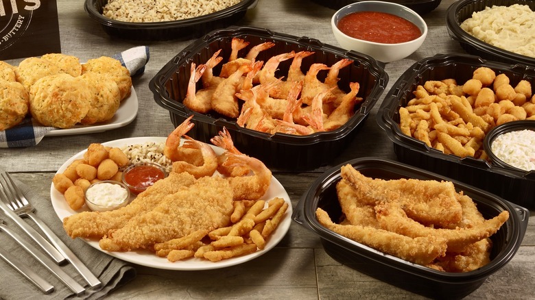 An assortment of Red Lobster fried fish and appetizers in to go containers