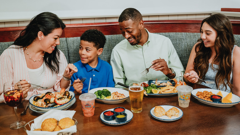 A smiling family dining at a Red Lobster restaurant