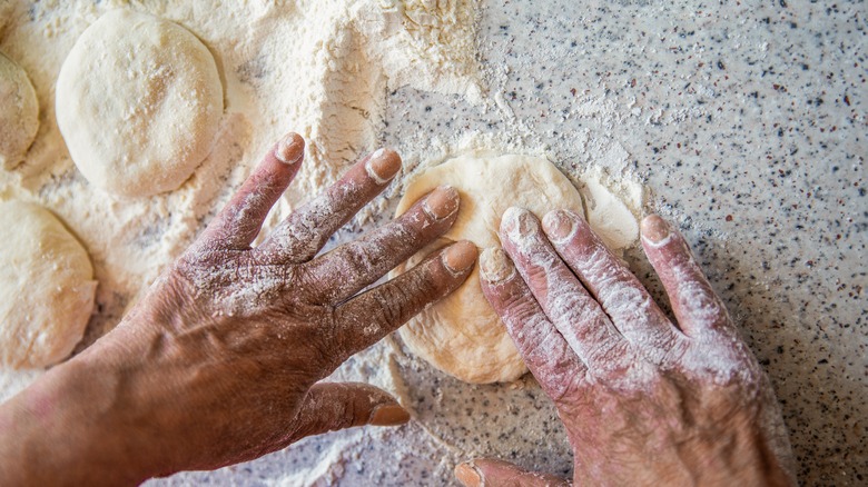 Person shaping tortilla dough