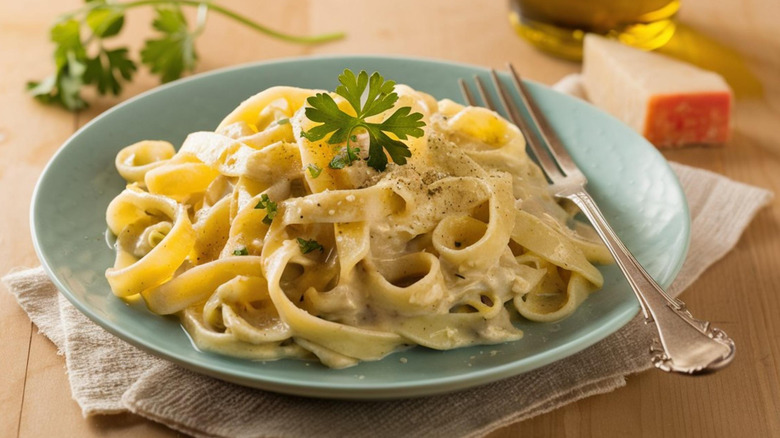 Fettuccine pasta with Alfredo sauce, garnished with parsley.