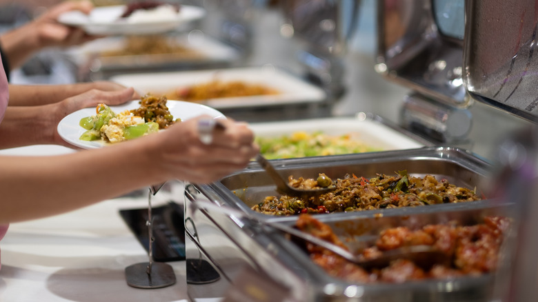 A person serving themselves at a buffet