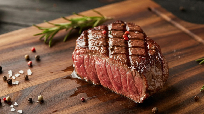 Sliced open steak on wood board